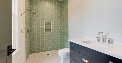 Bathroom With Blue Vanity & Green Tiled Shower ...