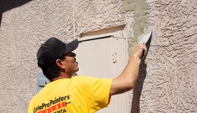 stucco of commercial building touching up
