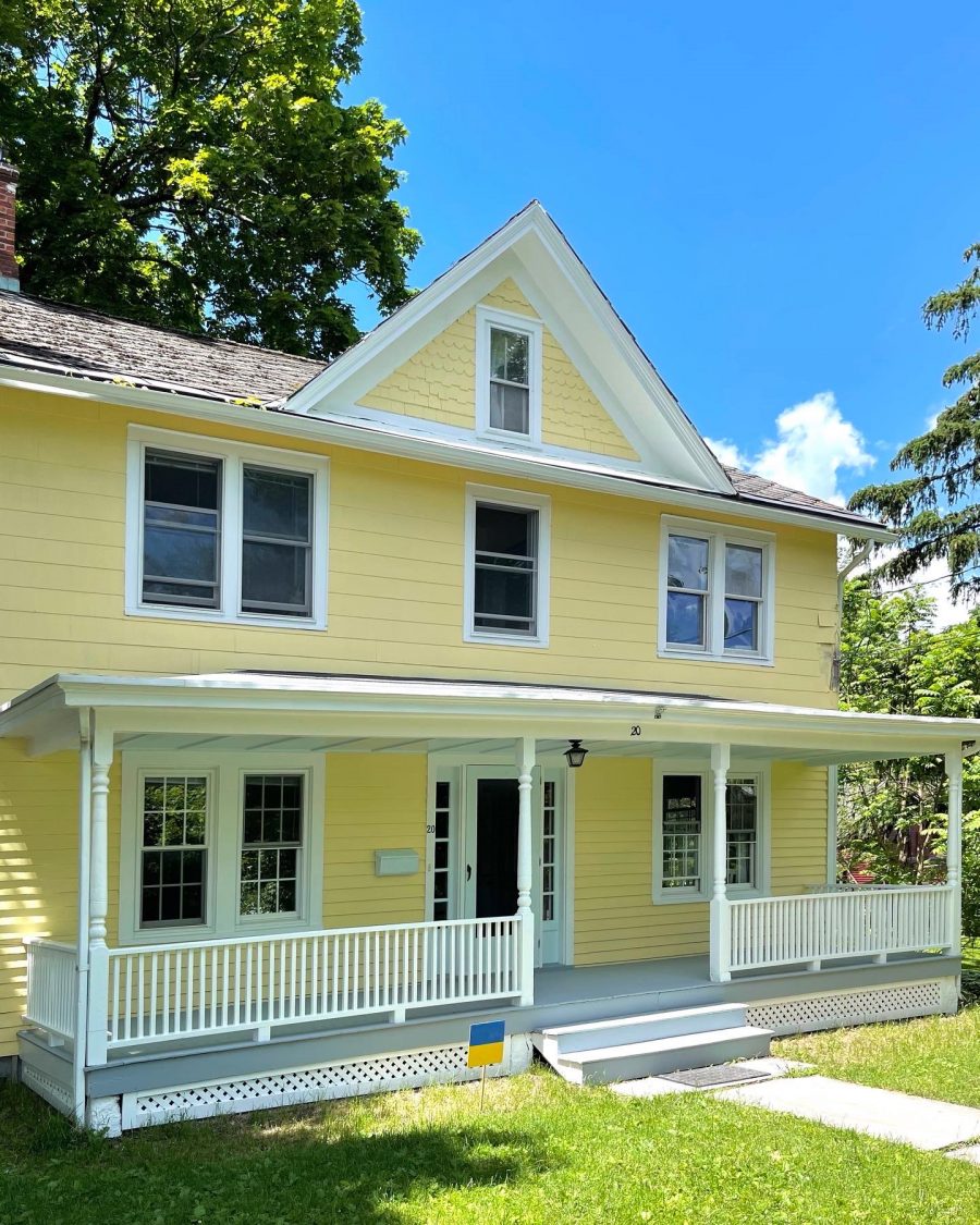 Side angle of house with yellow exterior in Warwick, NY, after completed residential exterior painting project by CertaPro Painters of Orange County, NY Preview Image 1