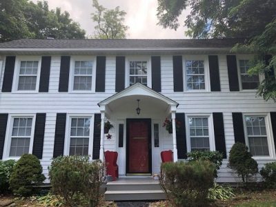 Front of white house with red door in Warwick, NY, after completed painting project by certapro painters of Orange County, NY