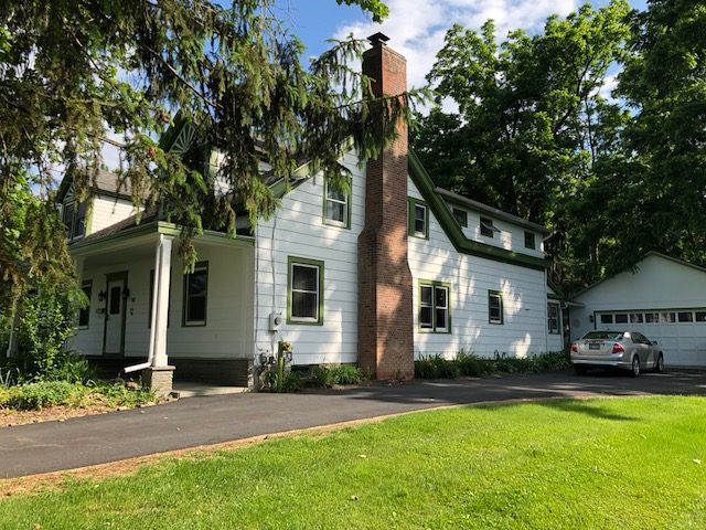 Side angle of St. James Church Rectory in Goshen, NY, after completed commercial exterior painting project by CertaPro Painters of Orange County, NY Preview Image 1