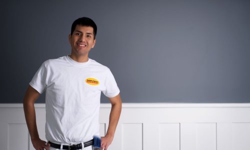 CertaPro Painters Crew Member posing in front of an interior wall