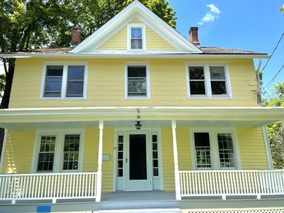 Front of yellow house in Warwick, NY, after completed residential exterior painting project by CertaPro Painters of Orange County, NY