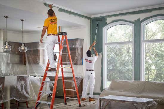 two certapro team members interior painting a home
