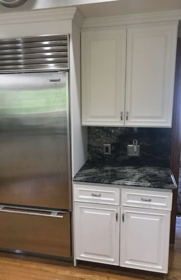 The cabinets next to the refrigerator were repainted. Preview Image 3