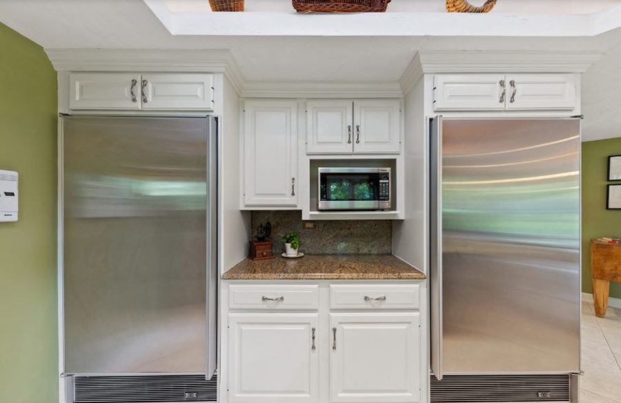 The kitchen cabinets between the refrigerators were painted white. Preview Image 2