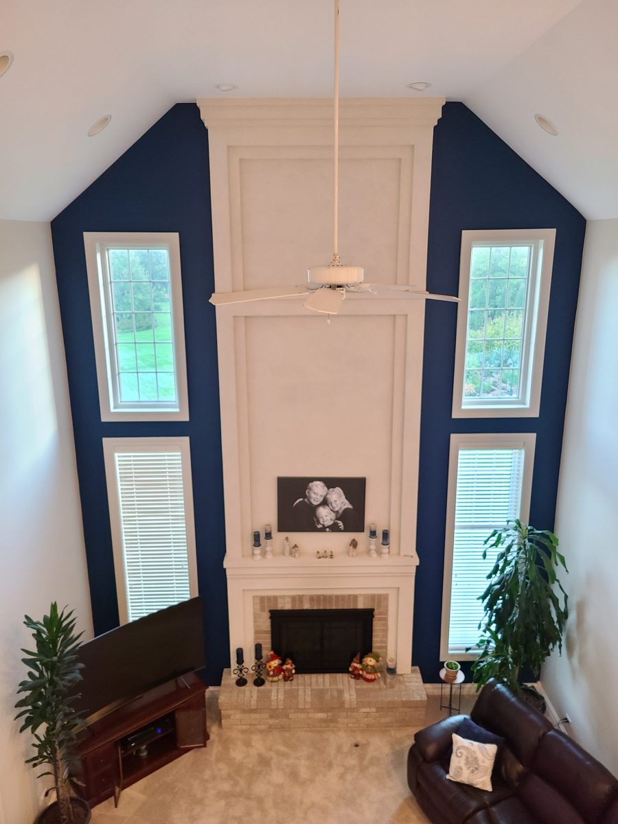 A living room with an accent wall painted dark blue. Preview Image 2