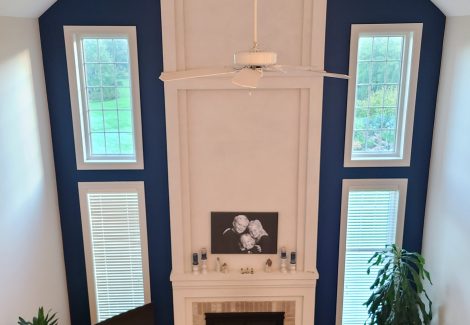 A living room with an accent wall painted dark blue.