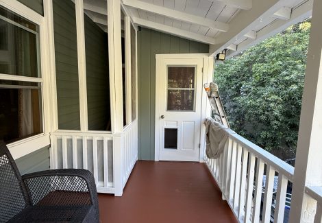 painted upper balcony of home and white door