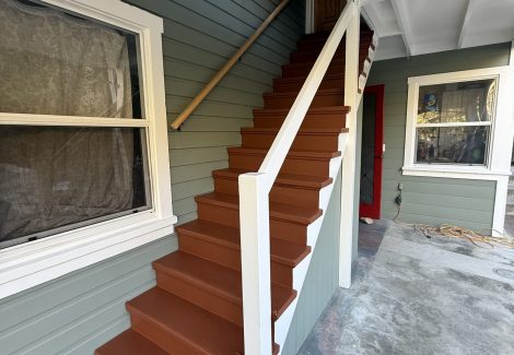covered exterior staircase of house with fresh paint