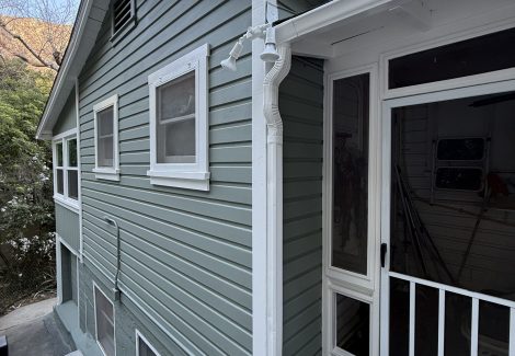 side of house with new light green paint and white trim