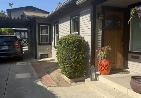 front and side view of painted house with dark trim