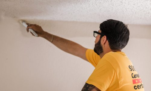 CertaPro supervisor painting ceiling