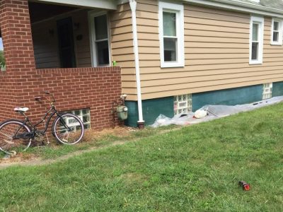 Bungalow with beige siding and white trim