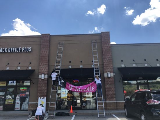CertaPro hanging the new T Mobile banner