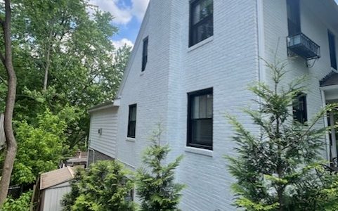 White brick tied into white siding and trim