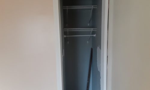 Closets with damaged doors and dark interiors