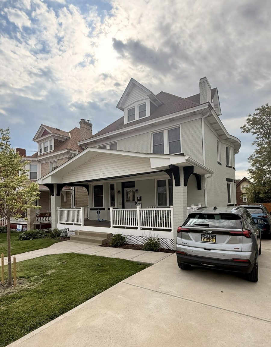 white painted brick home exterior with black accents. Preview Image 1