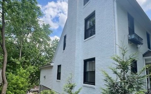White brick tied into white siding and trim