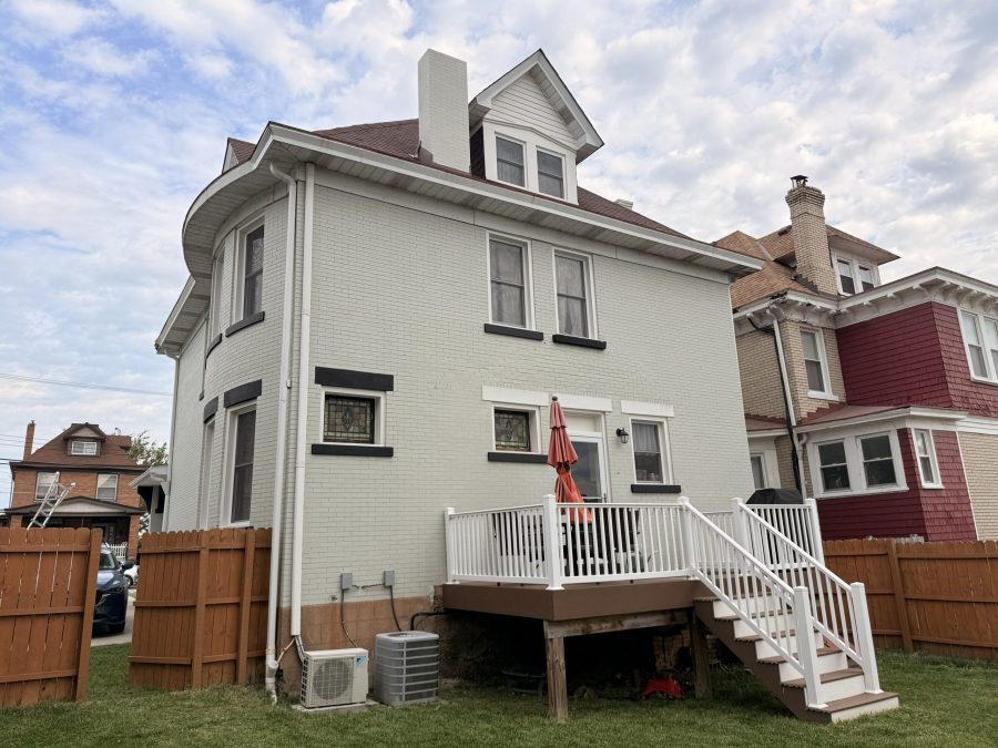 white painted brick home exterior with black accents. Preview Image 2
