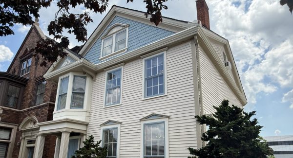repainted white brick and siding house exterior