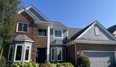 brick house with painted grey siding