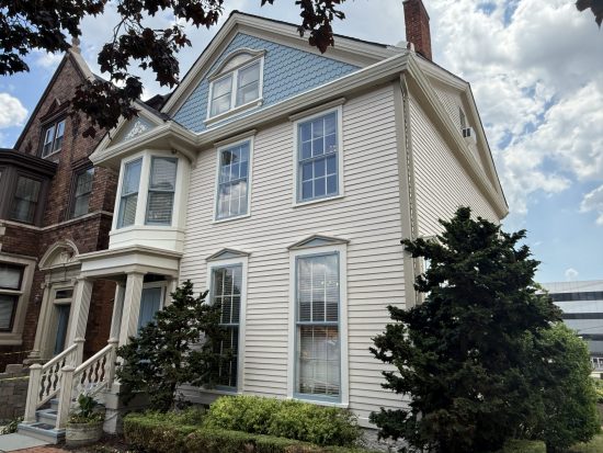repainted white brick and siding house exterior