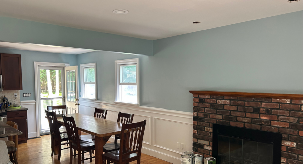 Wooden dining table in blue interior