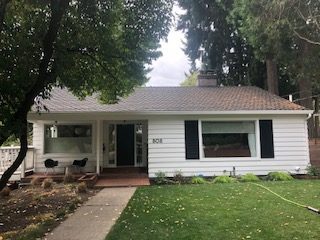 Ranch house with clapboard siding and shutters repainted in Southwest Portland Oregon.