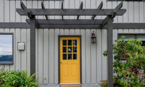 Shades of gray and a bold door color choice