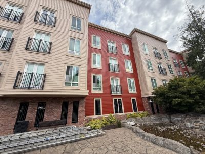 two-color painted siding and brick apartment buildings