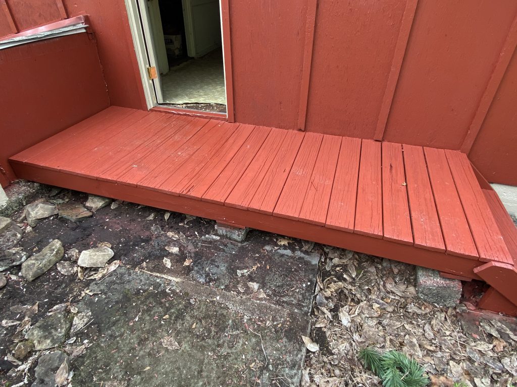 painted red wood porch in front of barn