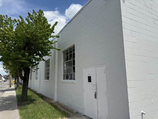 door and window on side of painted industrial building