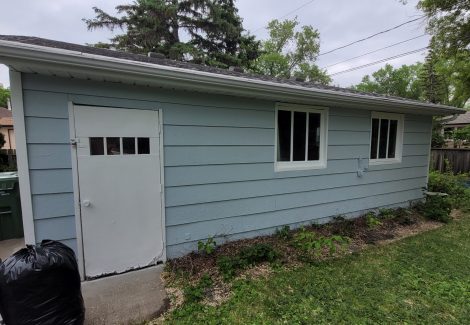 side of blue painted house