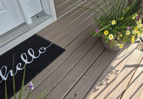 back of home with painted vinyl siding and deck