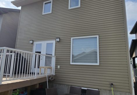back of home with painted vinyl siding