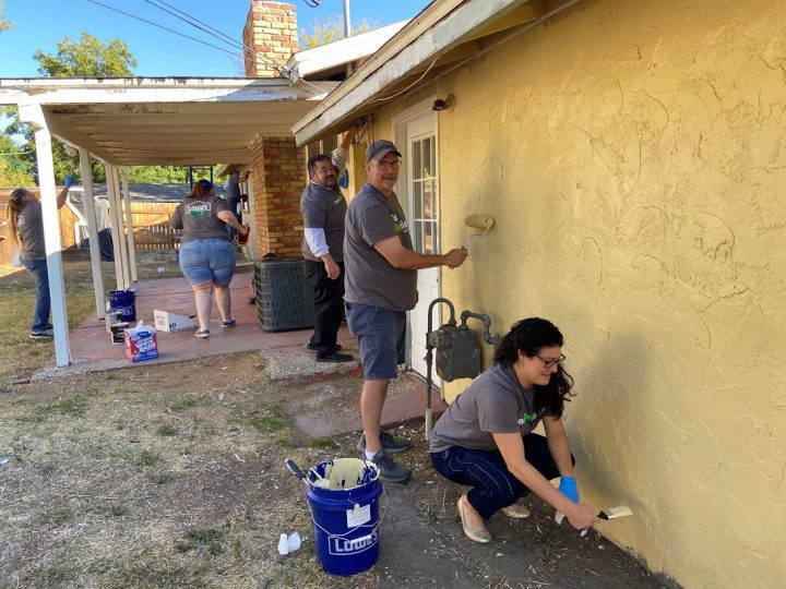 Charity group RebuildingNV painting a house.