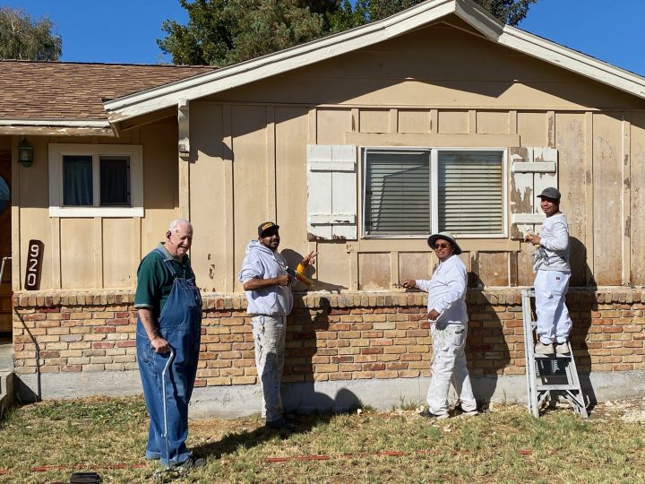 Volunteers repainting a house.