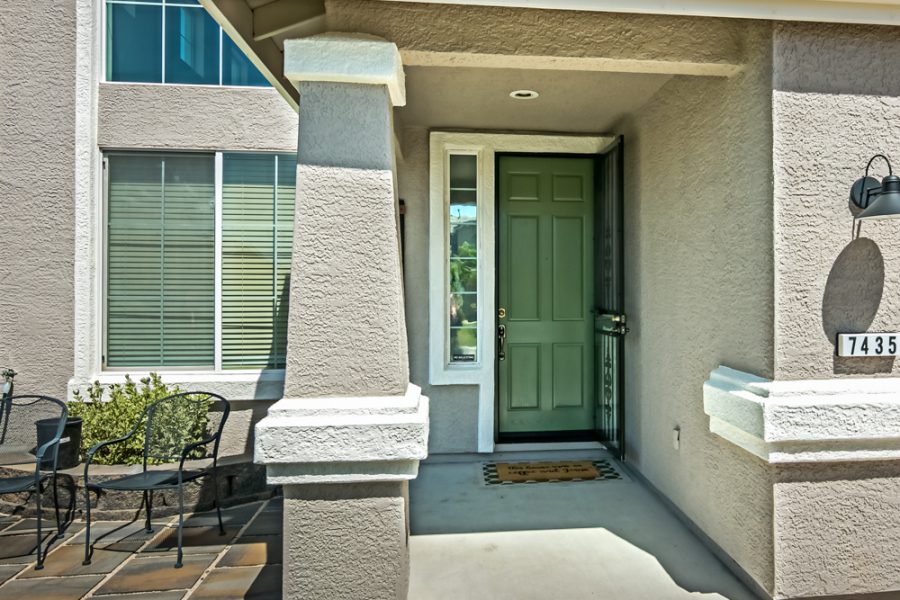 entrance to stucco home painted in two contrasting shades of tan. Preview Image 1