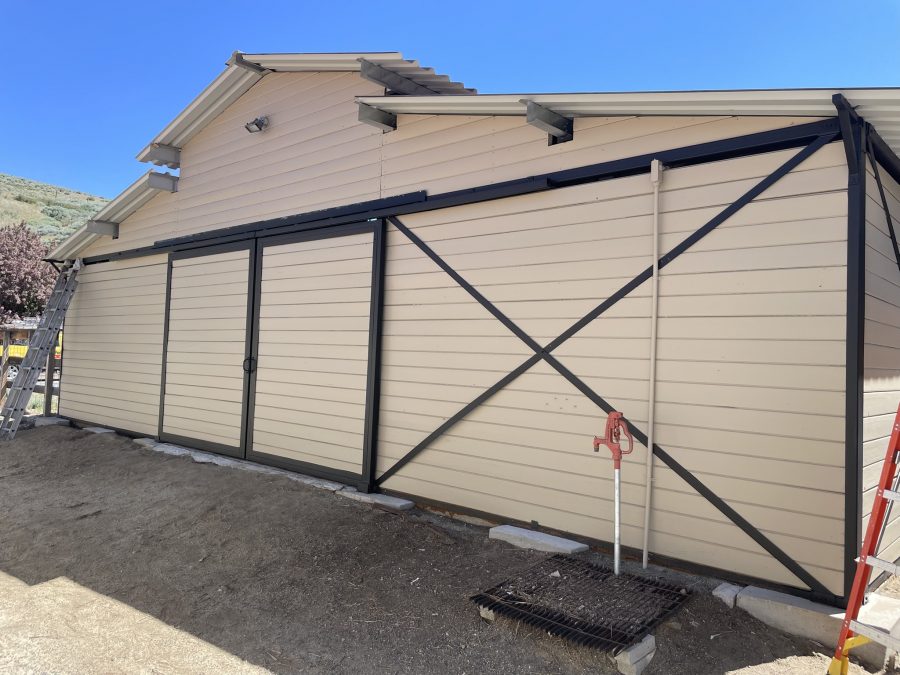 residential barn outbuilding with tan siding and black trim Preview Image 1