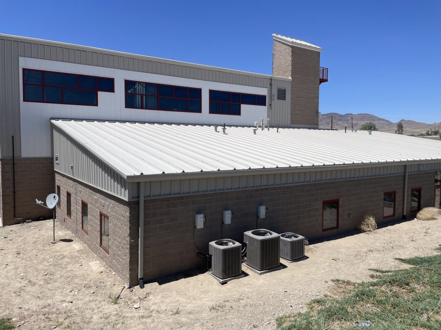 fire station with tan siding and dark red bay doors and trim Preview Image 4