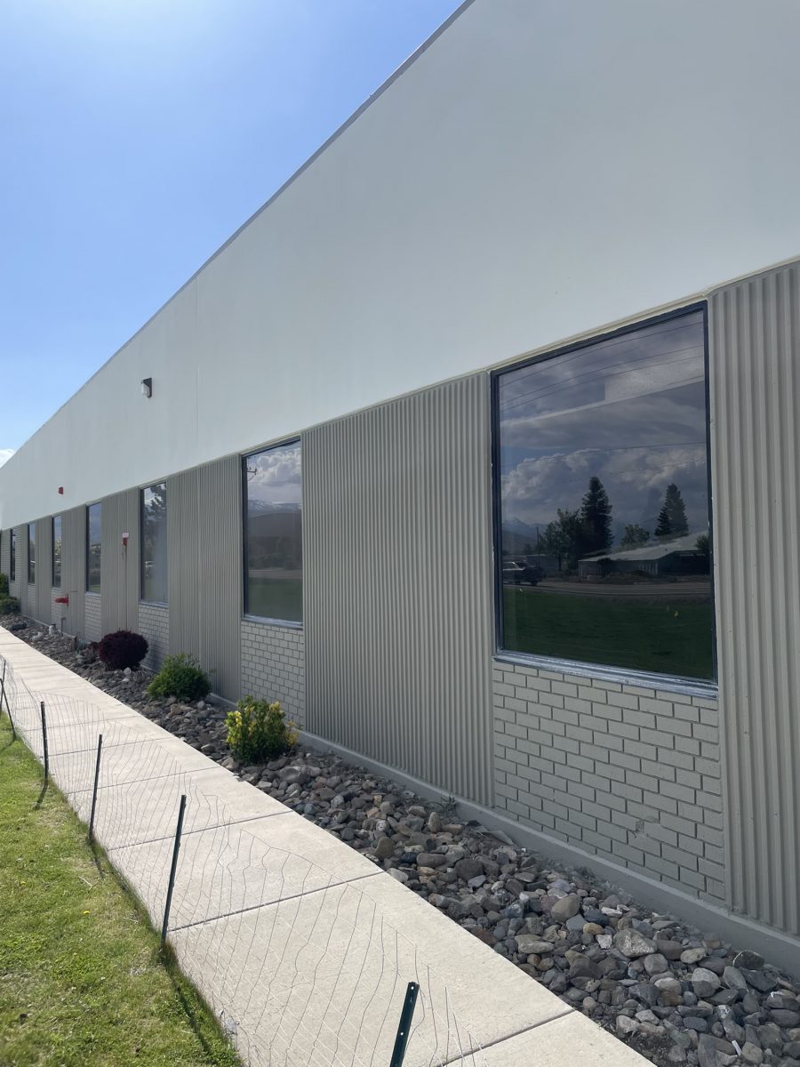 side of industrial building painted grey and white Preview Image 2