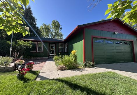 front of house with green siding and red trim