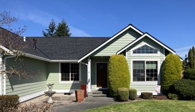 front exterior of house after light green repaint