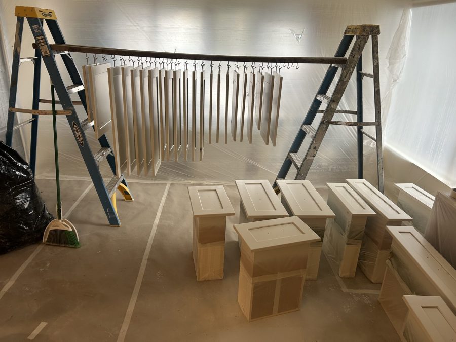 cabinet doors suspended on rack to dry after painting Preview Image 11