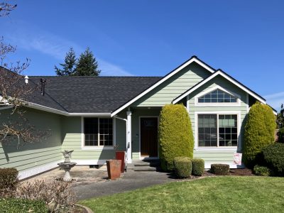 front exterior of house after light green repaint