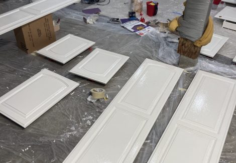 painted cabinet doors laid out to dry