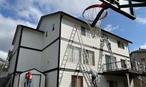 House in Progress with multiple ladders of our team painting using them