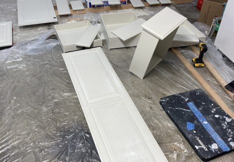 painted cabinet doors laid out to dry