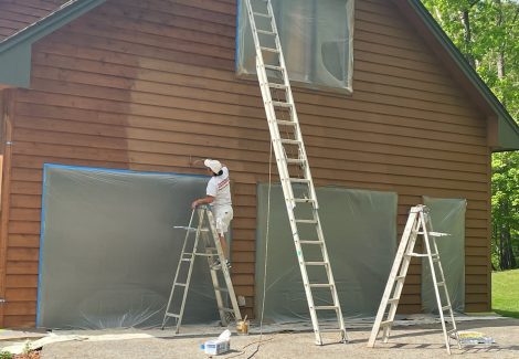 residential garage exterior during painting